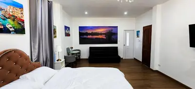 a bedroom with a bed and a couch in it at Tiny Island Lake Lodge in Bangkok