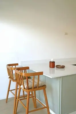 two chairs and a table with a white counter at 499 House Villa in Bangkok