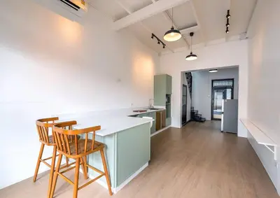 a kitchen with two chairs and a white counter top at 499 House Villa in Bangkok