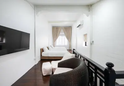 a white room with a bed and a couch at 499 House Villa in Bangkok
