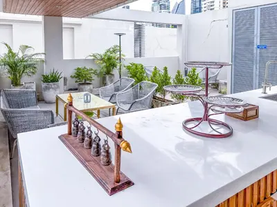 a chess board on a counter with chairs and tables at Sukhumvit-Thonglor Luxury Pool Club Villa 5 Mins to BTS \u7d20\u5764\u9038-\u901a\u7f85 \u8c6a\u83ef\u6703\u6240\u6cf3\u6c60\u5225\u5885 5\u5206\u9418\u5230\u9054\u5730\u9435 in Bangkok