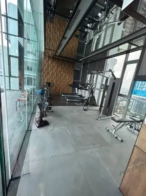 a gym with several exercise equipment in a building at 1BR at Thonglor BTS InfinityPool overlooking city in Bangkok