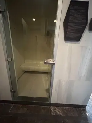 a bathroom with a shower with a glass door at 1BR at Thonglor BTS InfinityPool overlooking city in Bangkok