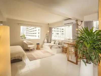 a living room with a couch and a table at Cozy studio room - 2 guests in the heart of Silom - 6B in Bang Rak
