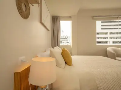 a white bedroom with a large bed with a window at Cozy studio room - 2 guests in the heart of Silom - 6B in Bang Rak
