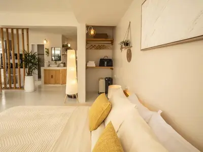 a bedroom with a white bed with yellow pillows at Cozy studio room - 2 guests in the heart of Silom - 6B in Bang Rak
