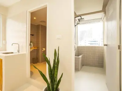 a bathroom with a shower and a potted plant at Cozy 2-bedroom apartment in Silom city center - 6A in Bang Rak
