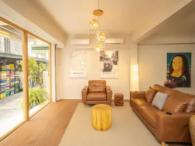 a living room with a couch and a chair at Cozy 2-bedroom apartment in Silom city center - 6A in Bang Rak