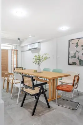 a dining room with a wooden table and chairs at Haus Ekkamai 2 in Khlong Toei