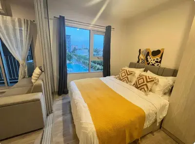 a bedroom with a large bed and a large window at Manmanlovehome in Bangkok