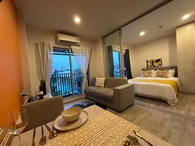 a large bedroom with a bed and a balcony at Manmanlovehome in Bangkok
