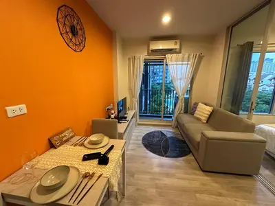 a living room with a couch and a table at Manmanlovehome in Bangkok