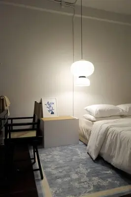 a bedroom with a bed and a lamp and a chair at Nap by Snooze in Bangkok