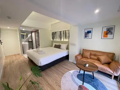 a hotel room with a bed and a couch at ZAYN Phrom Phong Hotel in Bangkok