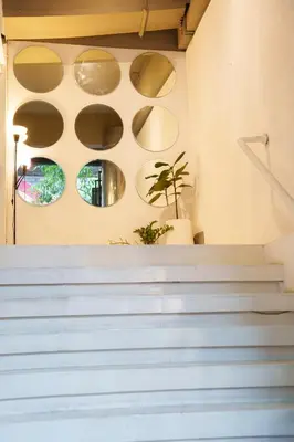 a set of stairs with plates on the wall at ZAYN Phrom Phong Hotel in Bangkok