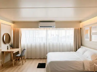 a bedroom with a bed and a desk and a window at ห้องพักเมืองทองธานี Happiness sleep C4 in Ban Bang Phang