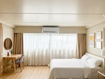 a bedroom with a bed and a desk and a window at ห้องพักเมืองทองธานี Happiness sleep C4 in Ban Bang Phang