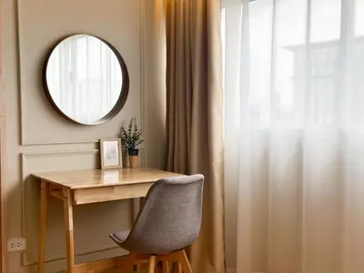 a table and a chair in a room with a mirror at ห้องพักเมืองทองธานี Happiness sleep C4 in Ban Bang Phang