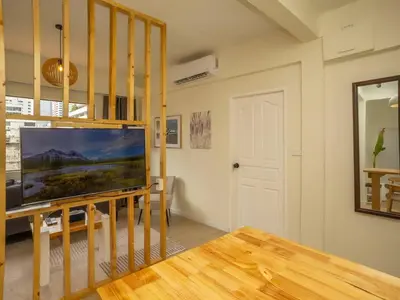 a living room with a flat screen tv on a table at 2 Bedroom apartment at Silom with city center view - 5A in Bangkok