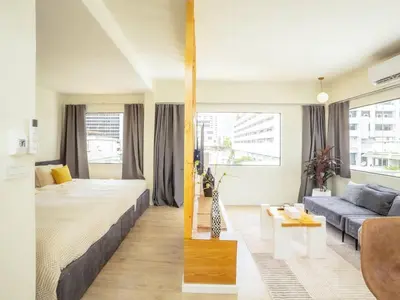 a bedroom with a large bed and a couch at Cozy studio room for 3 guests at Center-Silom - 5B in Bang Rak