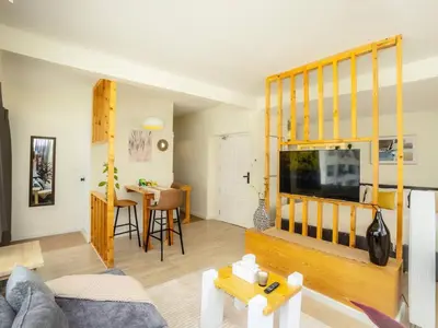 a living room with a couch and a flat screen tv at Cozy studio room for 3 guests at Center-Silom - 5B in Bang Rak