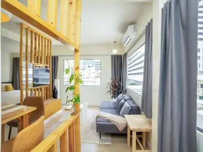 a living room with a couch and a table at Cozy studio room for 3 guests at Center-Silom - 5B in Bang Rak