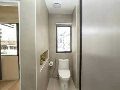 a small bathroom with a toilet and a window at Cozy studio room for 3 guests at Center-Silom - 5B in Bang Rak
