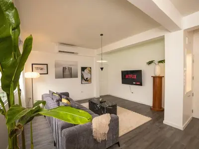 a living room with a couch and a tv at 2-Bedroom Penthouse in the heart of Silom - 4A in Bang Rak