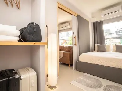 a small room with a bed and a suitcase at 2-Bedroom apartment for 4 guests, Center-Silom - 3A in Bang Rak