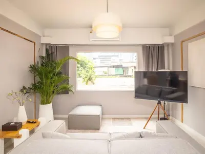 a living room with a white couch and a flat screen tv at 2-Bedroom apartment for 4 guests, Center-Silom - 3A in Bang Rak