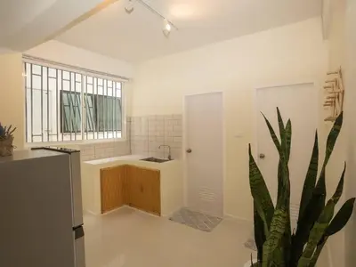 a kitchen with a plant in the middle of a room at 2-Bedroom apartment for 4 guests, Center-Silom - 3A in Bang Rak