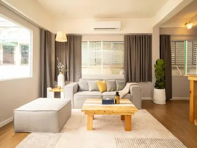 a living room with a couch and a table at Cozy studio for 3 guests in the heart of Silom - 3B in Bang Rak