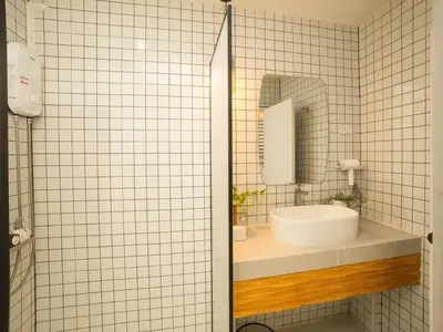 a bathroom with a sink and a mirror at Cozy studio for 3 guests in the heart of Silom - 3B in Bang Rak