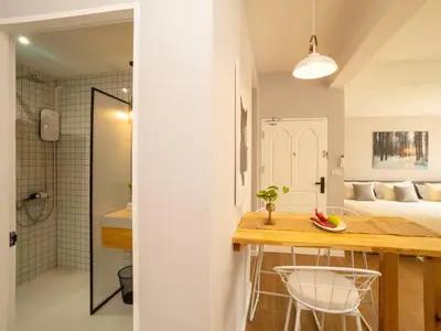 a bathroom and a bedroom with a bed and a counter at Cozy studio for 3 guests in the heart of Silom - 3B in Bang Rak