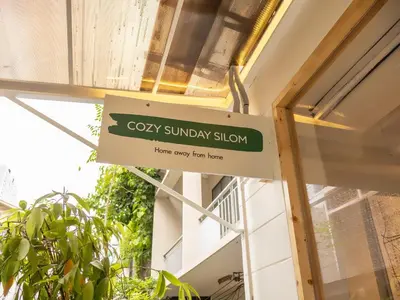 a sign for a cosy sunday show on a building at Cozy studio for 3 guests in the heart of Silom - 3B in Bang Rak
