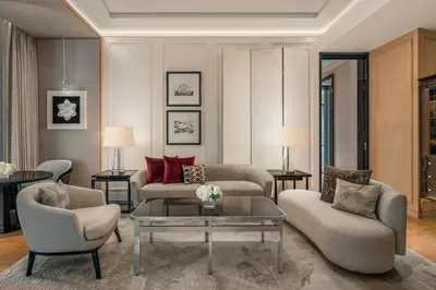 a living room with a couch and a coffee table at The Ritz-Carlton, Bangkok in Bangkok