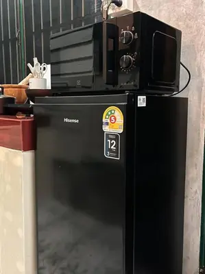 a black refrigerator with a tv on top of it at Thairin House Old town BKK in Dusit