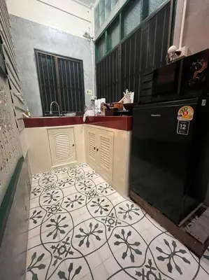 a kitchen with a sink and a microwave at Thairin House Old town BKK in Dusit