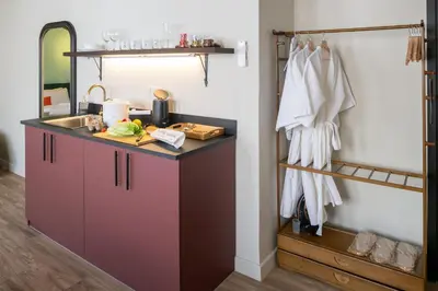 a bathroom with a counter with a sink and a sink at Boutique hotel Axis Bangkok in Bangkok