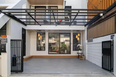 an external view of a house with a balcony at Boutique hotel Axis Bangkok in Bangkok