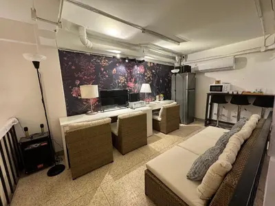 a room with couches and a table with a piano at Twenty Two Place Hostel - Sukhumvit 22 in Bangkok