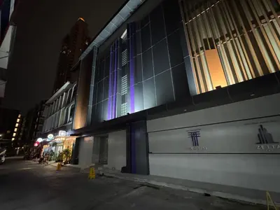 a building with blue lights on the side of it at Twenty Two Place Hostel - Sukhumvit 22 in Bangkok