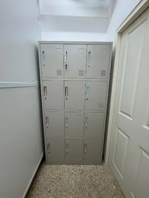 a bunch of lockers in a room with a door at Twenty Two Place Hostel - Sukhumvit 22 in Bangkok