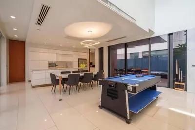 a kitchen and dining room with a ping pong table at Ekkamai Villa Sleeps 12 with Cinema in Bangkok