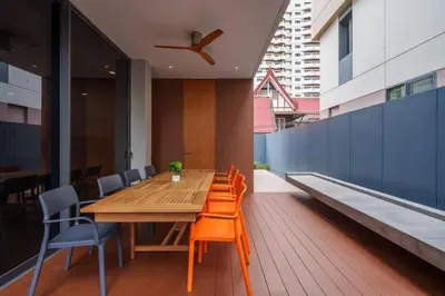 a dining room with a wooden table and chairs at Ekkamai Villa Sleeps 12 with Cinema in Bangkok