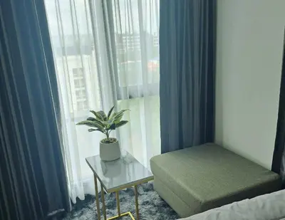 a room with a plant on a table next to a window at Cybiq Ratchada 32 by Pikul in Bangkok
