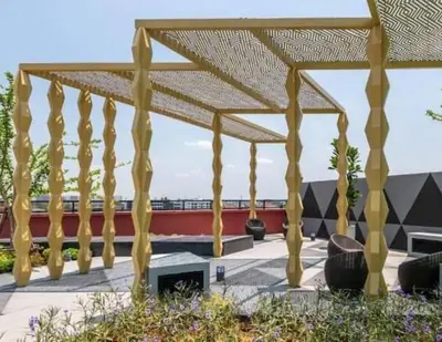 a wooden pergola with a fireplace on a patio at Cybiq Ratchada 32 by Pikul in Bangkok