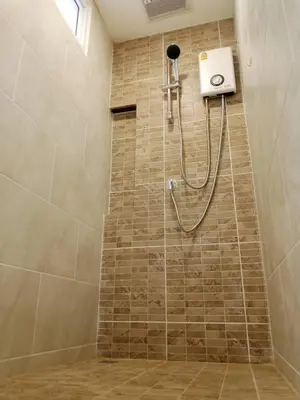 a shower with a shower head in a bathroom at Wellness World Chiva 89 in Ban Zong Katiam