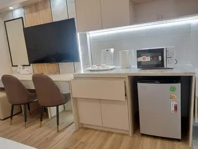 a kitchen with a counter with a microwave and a refrigerator at Wellness World Chiva 89 in Ban Zong Katiam