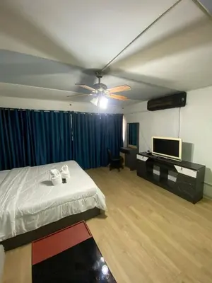 a bedroom with a bed and a flat screen tv at ไอริน ห้องพักรายวัน 2 in Thung Si Kan